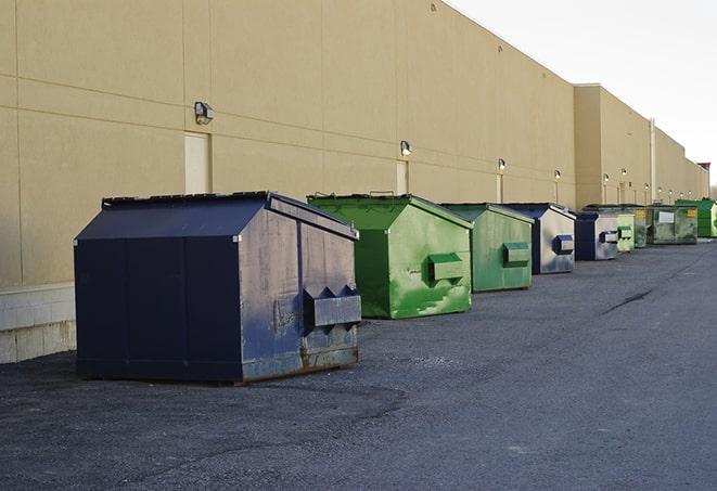 portable, green construction dumpsters serving as a container for scrap materials in East Windsor